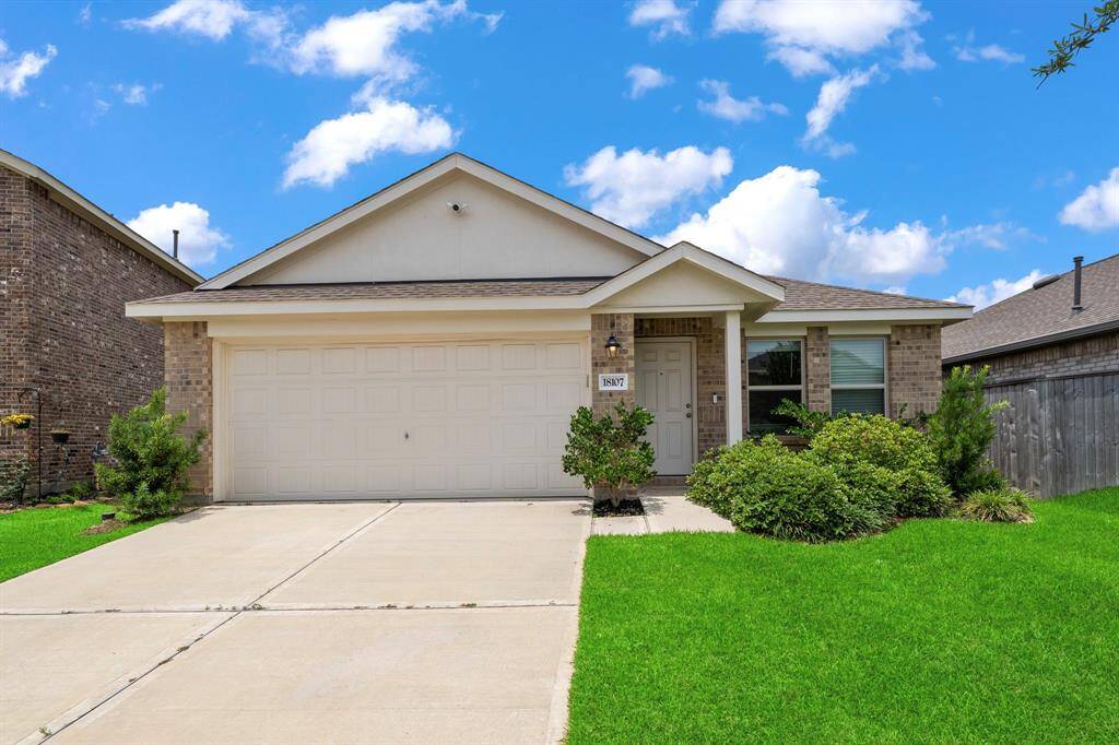 The house boasts a charming brick and cement board exterior with a welcoming covered entry porch.