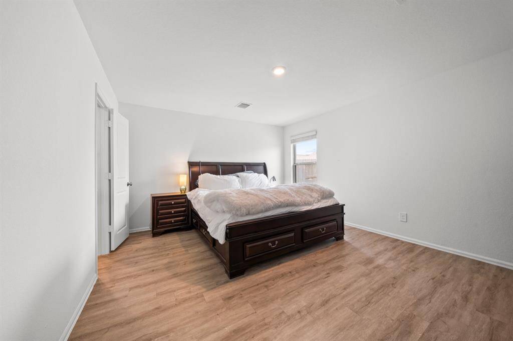 The primary bedroom also includes a spacious walk-in closet, offering ample storage and organization for clothing and accessories.