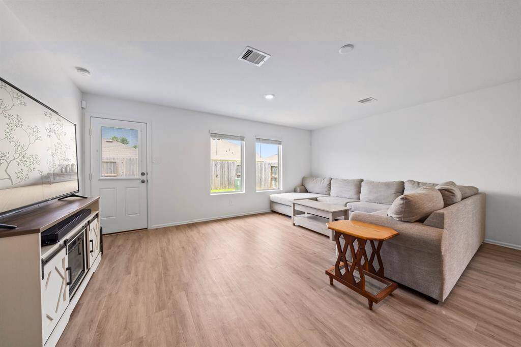 The living area is open to the kitchen and dining, fostering a spacious and connected atmosphere.