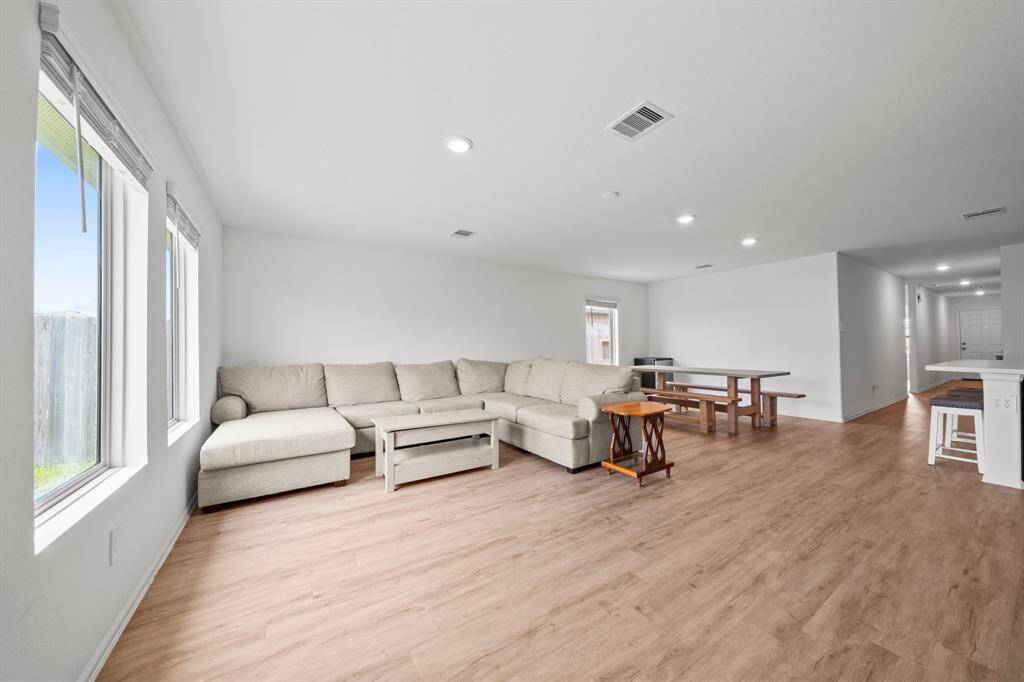 Ample natural light flows in through backyard-facing windows, brightening the entire space.