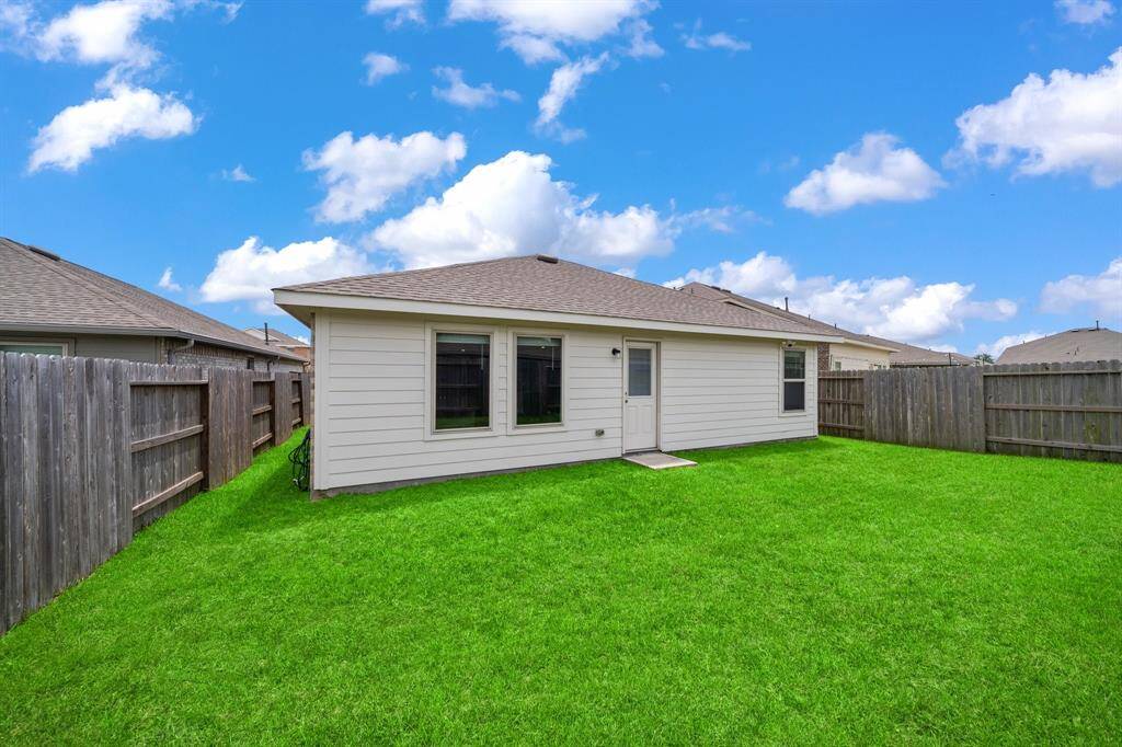 The backyard is small yet manageable, ideal for low-maintenance outdoor living.