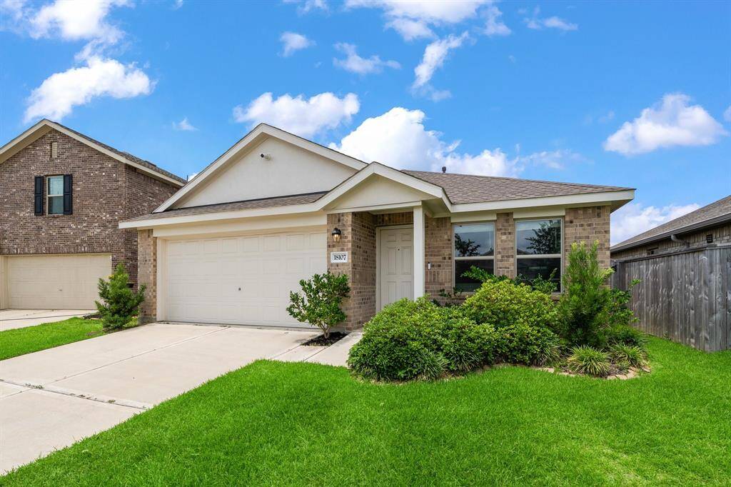 The attached two-car garage and fresh landscaping enhance the home's curb appeal in the desirable Becker Trace community.