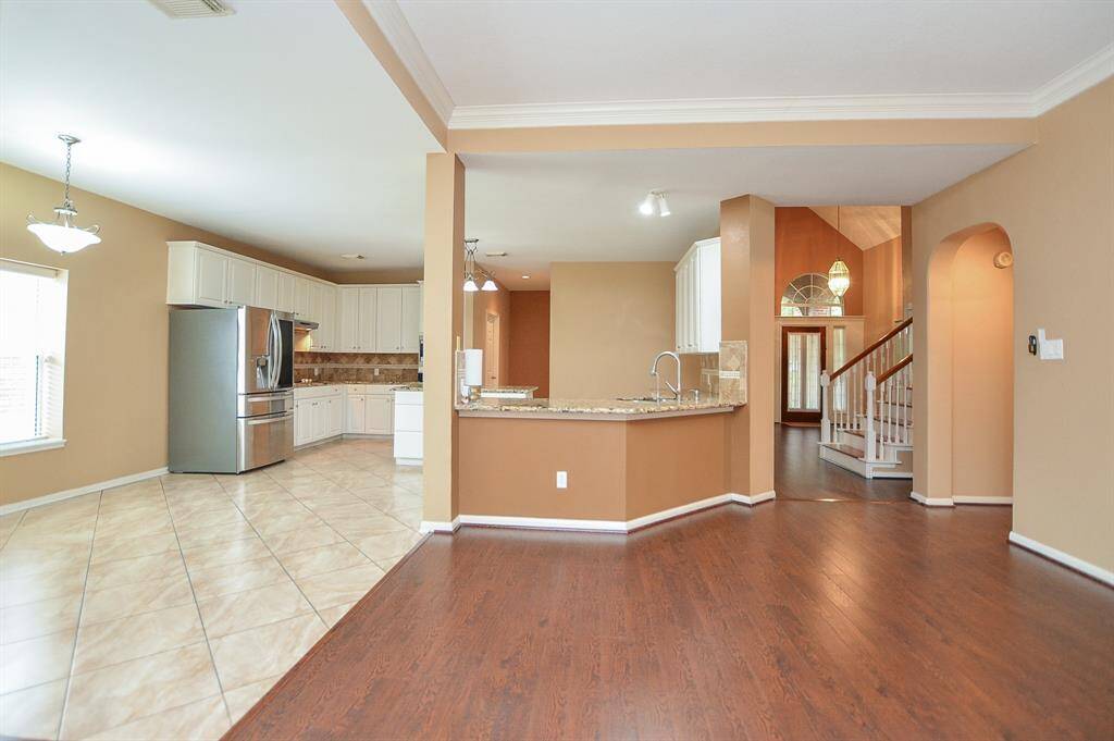 The beauty and versatility of the open floor plan design concept is alive and well in this vast, combined living/kitchen/dining area on the 1st level. From this vantage point, you have a clear view from this common area, right to the front door!