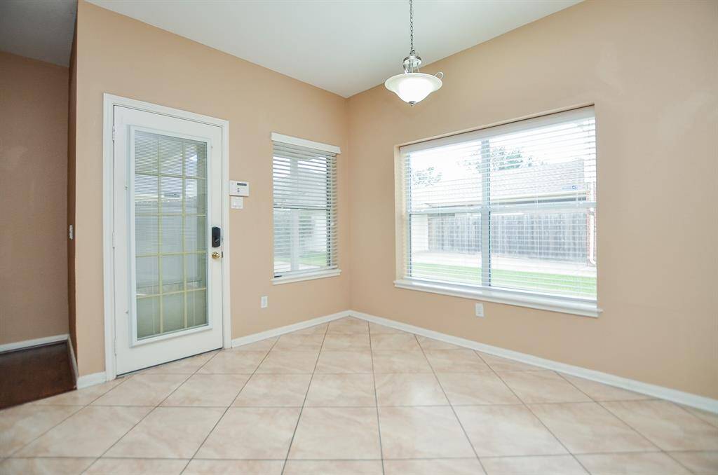 This spacious breakfast nook looks out onto patio and your personal patch of green!