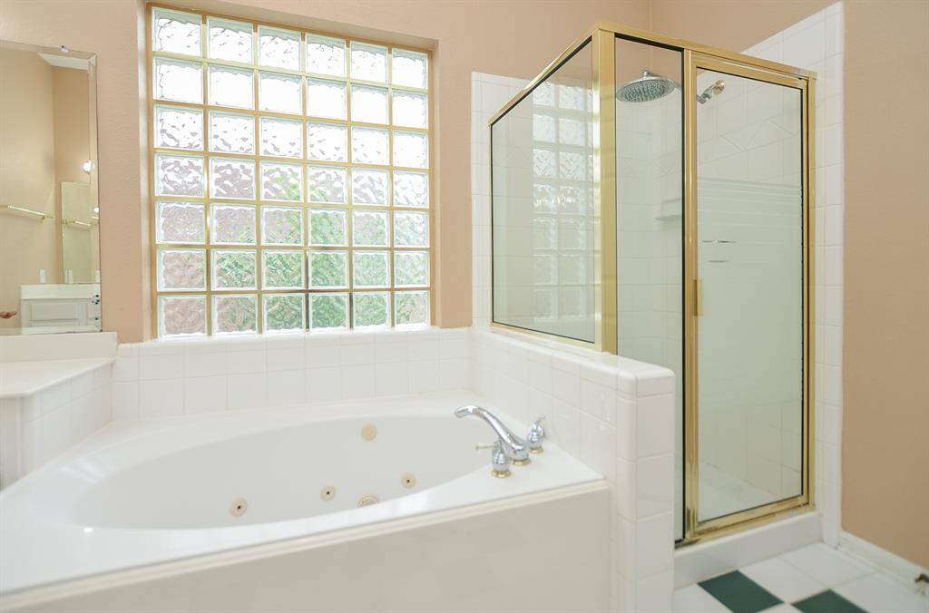 Here's your luxurious jetted, garden tub under art-deco like window panes, and right next to the glass enclosed shower; both of which are waiting for you when move-in day comes to a close!