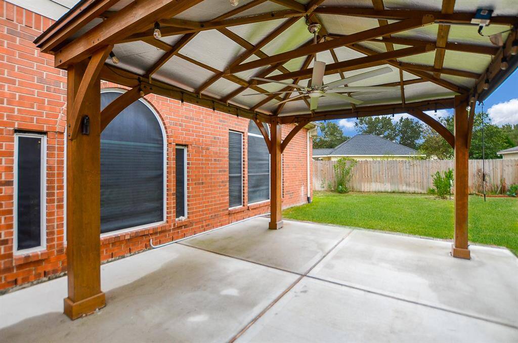 This gazebo like structure on the pristine, paved patio offers shade in a most sophisticated way; while open lawn areas offer sunshine, too!