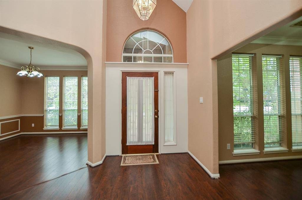 The magnificent front entry/foyer from the inside is a sublime gathering of wall-wide windows for plenty of natural light; incredible floor and wall space, and sophisticated earth tones and accents/crown molding on walls. Gorgeous hardwood floors grace all areas on the 1st floor.
