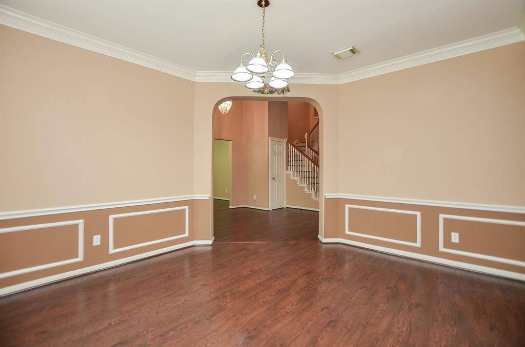 What a satisfying view from what may become your formal dining area into the main hallway, with a peek at the staircase, beyond.