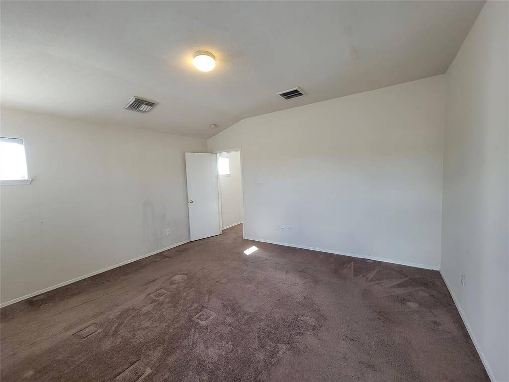 Discover the expansive comfort of this generously sized primary bedroom, offering ample space for relaxation and personalization.