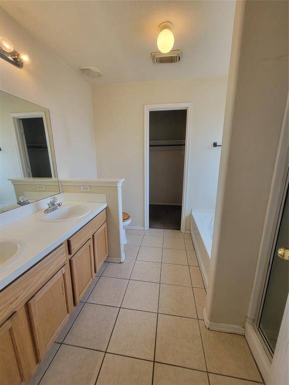 Experience the luxury of convenience in this master suite featuring an ensuite bath with a dedicated soaking tub and separate shower for ultimate relaxation and privacy.
