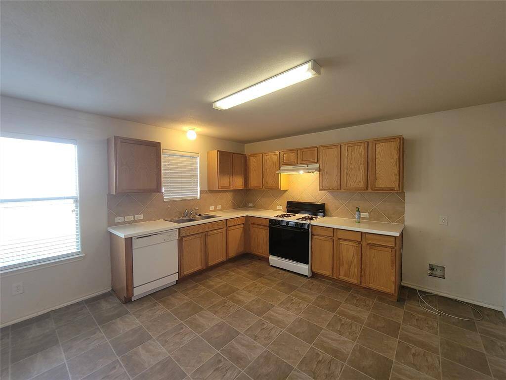 Inviting kitchen with warm wood cabinetry and ample natural light.