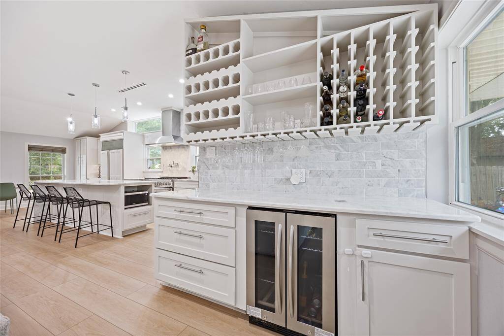 Custom Dry Bar with Wine Rack, Beverage Fridge & Glass Display StorageEntertainer’s dream: this custom bar features built-in wine storage, glassware racks, and dual-zone beverage refrigeration—perfect for hosting.