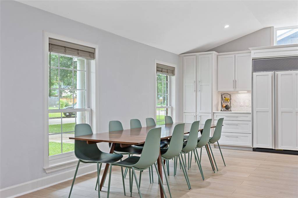 Dining Room with Wall-to-Wall WindowsBright and airy dining space with oversized energy-efficient windows. Perfect for natural light lovers seeking open-concept dining in updated Houston homes.