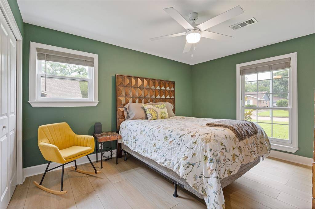 Guest Bedroom with Green Accent Wall and Double WindowsCharming and cozy with great light, this secondary bedroom is ideal for guests, teens, or a dedicated workspace—featuring upgraded trim and ceiling fan.