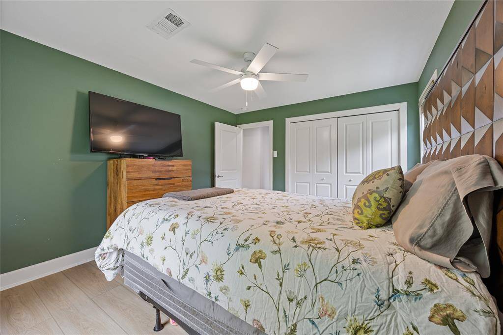 Guest Bedroom with Dual Closets and Ceiling FanSpacious secondary bedroom with custom paint, dual-door closet storage, and ceiling fan—ideal for a guest suite or home office setup.