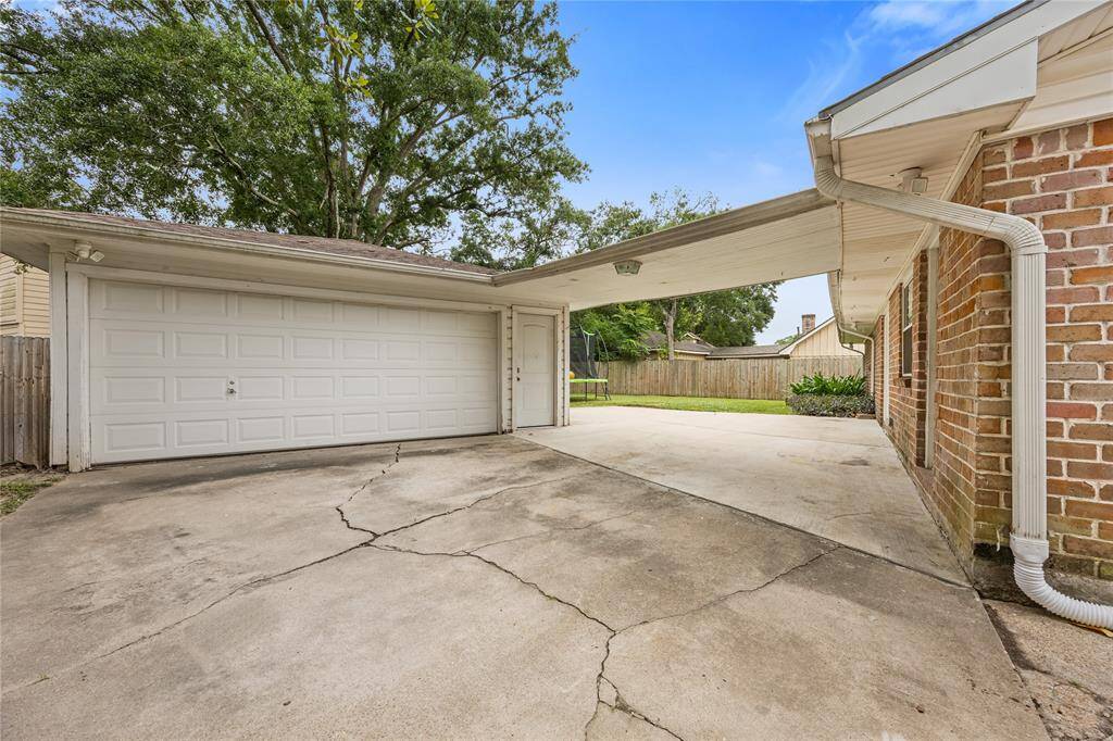 Detached Garage + Breezeway DrivewayExtended driveway leads to a detached two-car garage with breezeway, offering shaded access to the home. A rare find in the area, this setup enhances curb appeal and functionality.