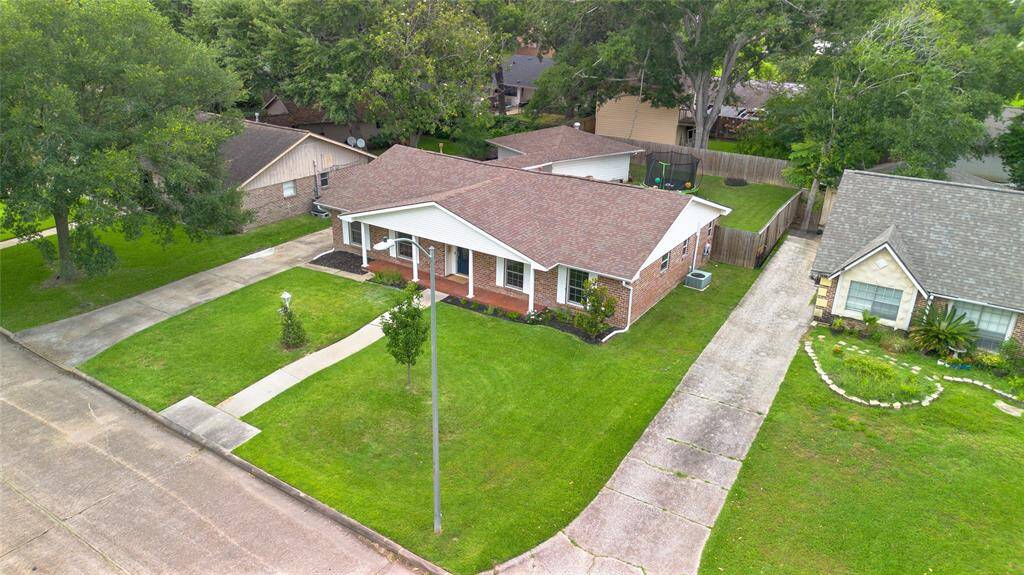 Front of HomeClassic curb appeal with a brick façade, manicured lawn, and welcoming front porch. The wide driveway and covered entry set the tone for this move-in-ready home.