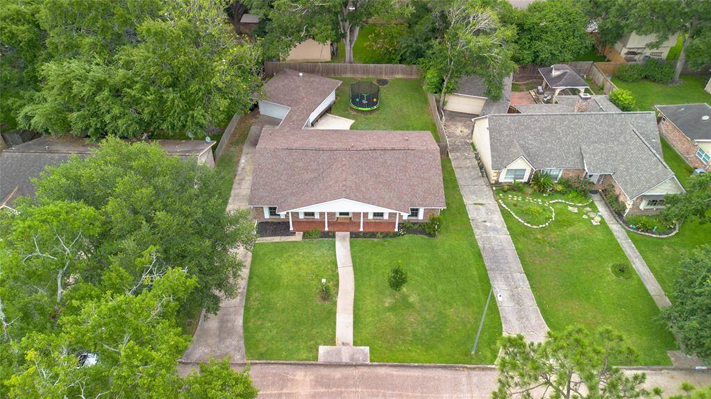 Aerial View of PropertyA stunning aerial shot showcases the full footprint of this property, including the extended driveway, detached garage, and spacious private backyard.
