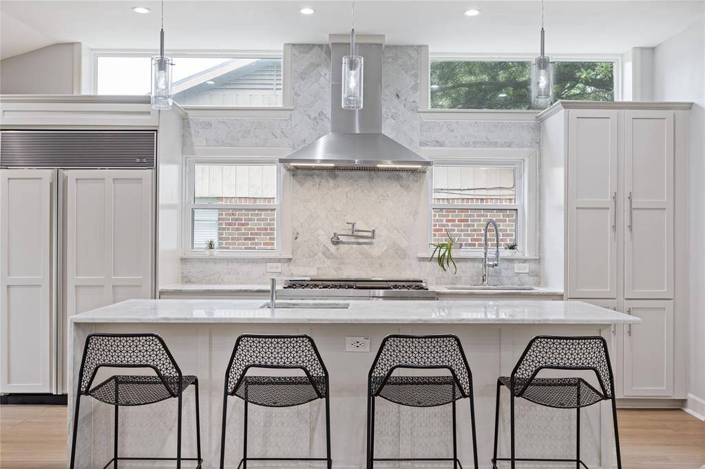 Full View of Marble Backsplash and ZLINE Gas Range with Pot FillerHighlighting the premium ZLINE 48” dual oven range, marble tile detail, and upgraded ventilation hood. Ideal for serious home cooks and entertainers.