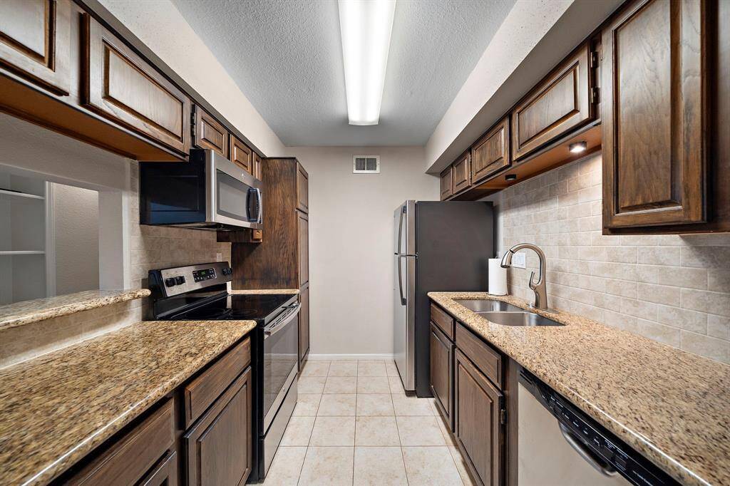 Functional kitchen with updates, all SS appliances included, and plenty of storage and work space.