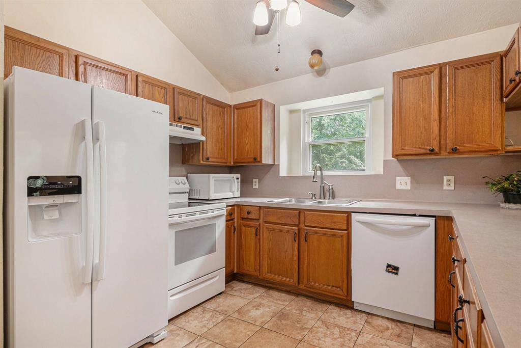 This kitchen features lots of cabinet space and natural light.