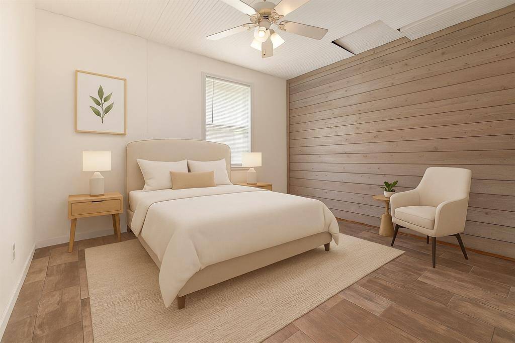 View of the spacious bedroom in the mother-in-law suite. (Virtually Staged)