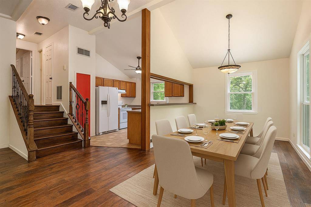 Formal dining room off the kitchen and breakfast bar seating. (Virtually Staged)