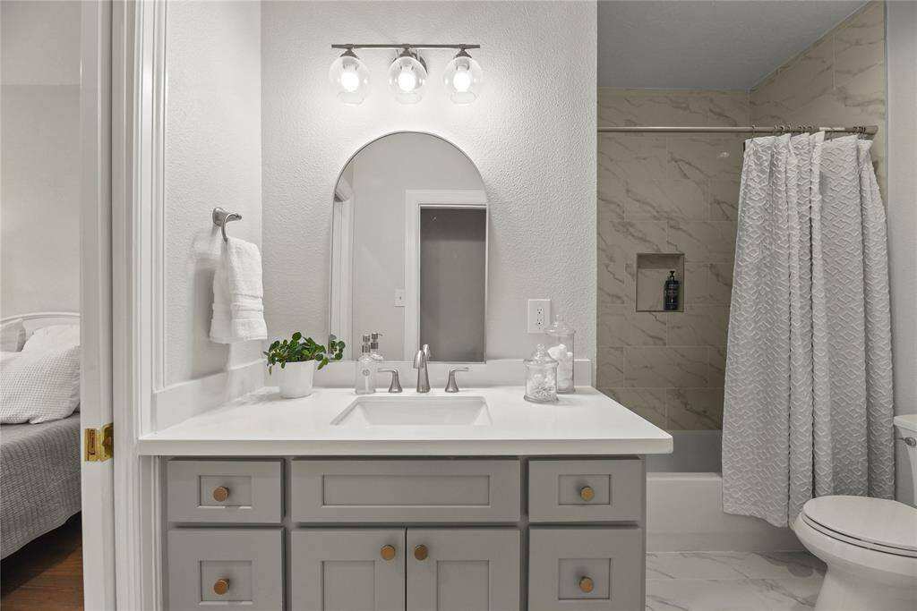 And a beautiful bathroom. Recent floors, cabinets, counters, tile surround and more!