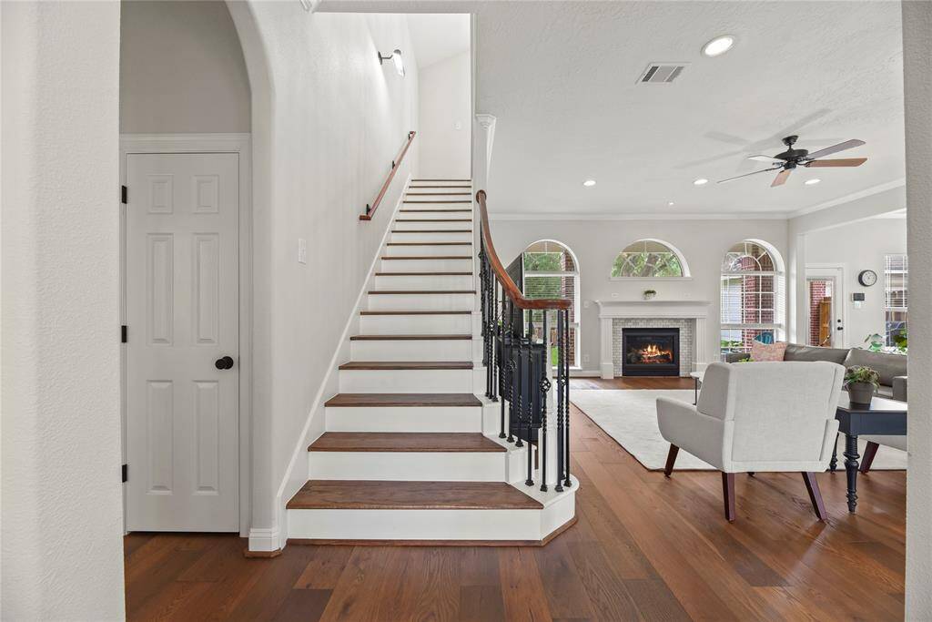 Wood stairs with white risers sweep you upstairs!