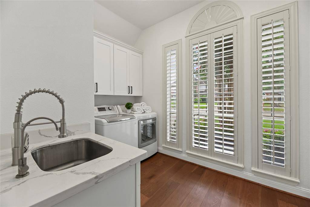 The laundry room has a sink, cabinets....