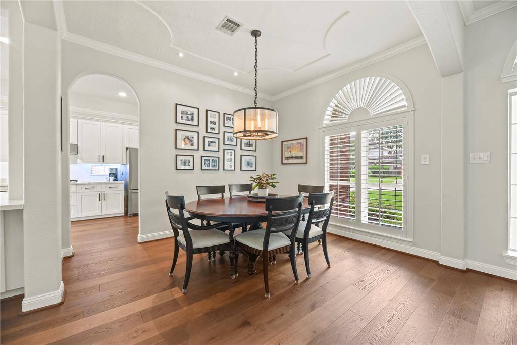 Classic architectural design with custom ceiling details, crown molding and plantation shutters-this home is sure to catch you eye!