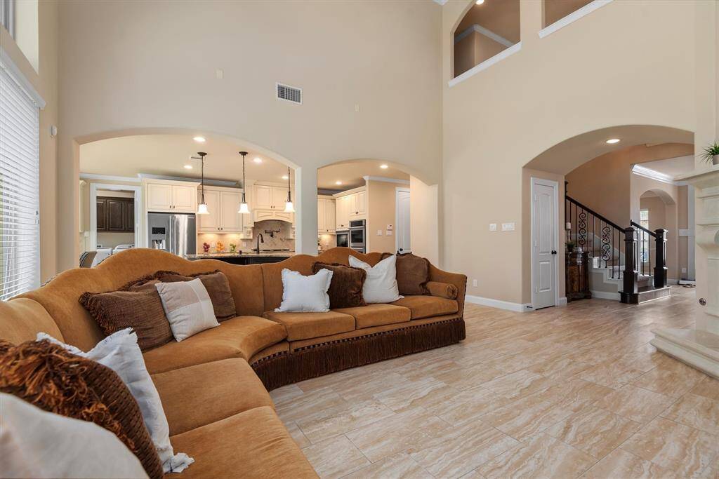The elegant living room flows effortlessly into a spacious, beautifully designed kitchen creating the perfect open-concept layout for modern living.