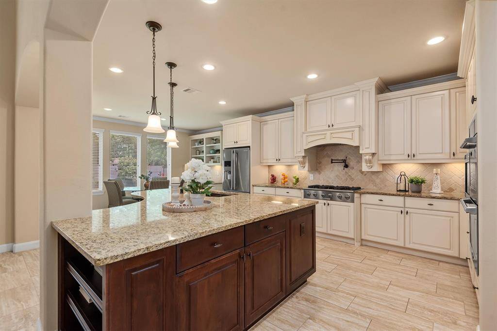This beautifully updated kitchen blends modern style with everyday functionality. Featuring sleek countertops, custom cabinetry, designer lighting, and top-of-the-line appliances, it’s a space that impresses at every turn.