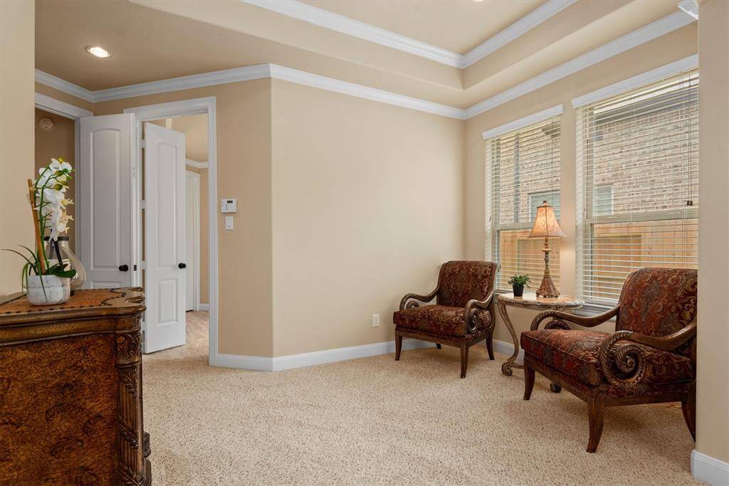 The primary bedroom features a charming seating area, ideal for creating your own quiet retreat, workout space, nursery or second office space.
