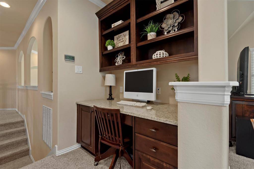 Perfectly positioned at the top of the stairs, this built-in homework station offers a quiet and organized space for studying, working from home, or managing household tasks.