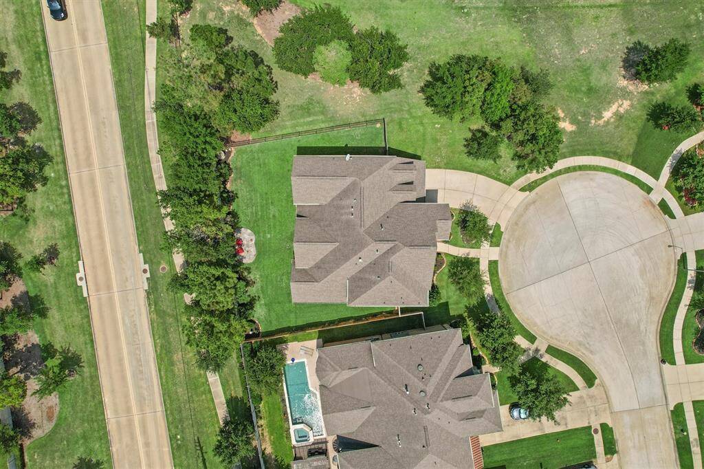 An aerial view reveals the true gem that this property is- a prime location with ample green space and natural surroundings. This peaceful setting is perfection.
