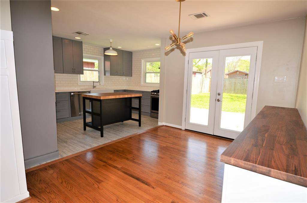 Dining room with tasteful selected light fixture and double french doors, easy access to deck and backyard