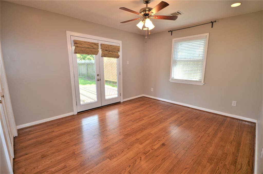 Spacious master bedroom with french doors to backyard.