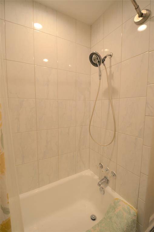 Shower tub with bright wall tile.