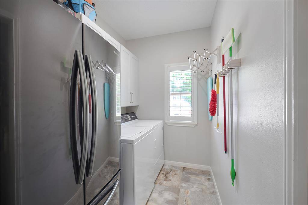 The utility room is just off the hallway and has 42" cabinets and space for a full sized refrigerator. There is also a small closet area for storing additional pet and cleaning needs.