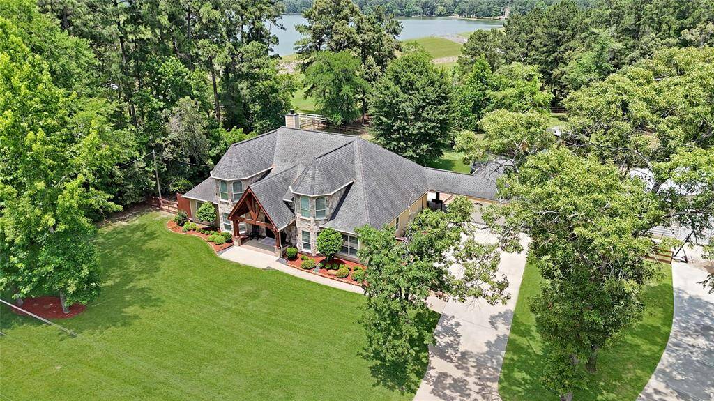 The home is located just steps from the resident only lake and next door to the quiet community park. Surrounded by tall pines and set well back from the street, this 2.5+ acre homestead enjoys a peaceful retreat-like feel.
