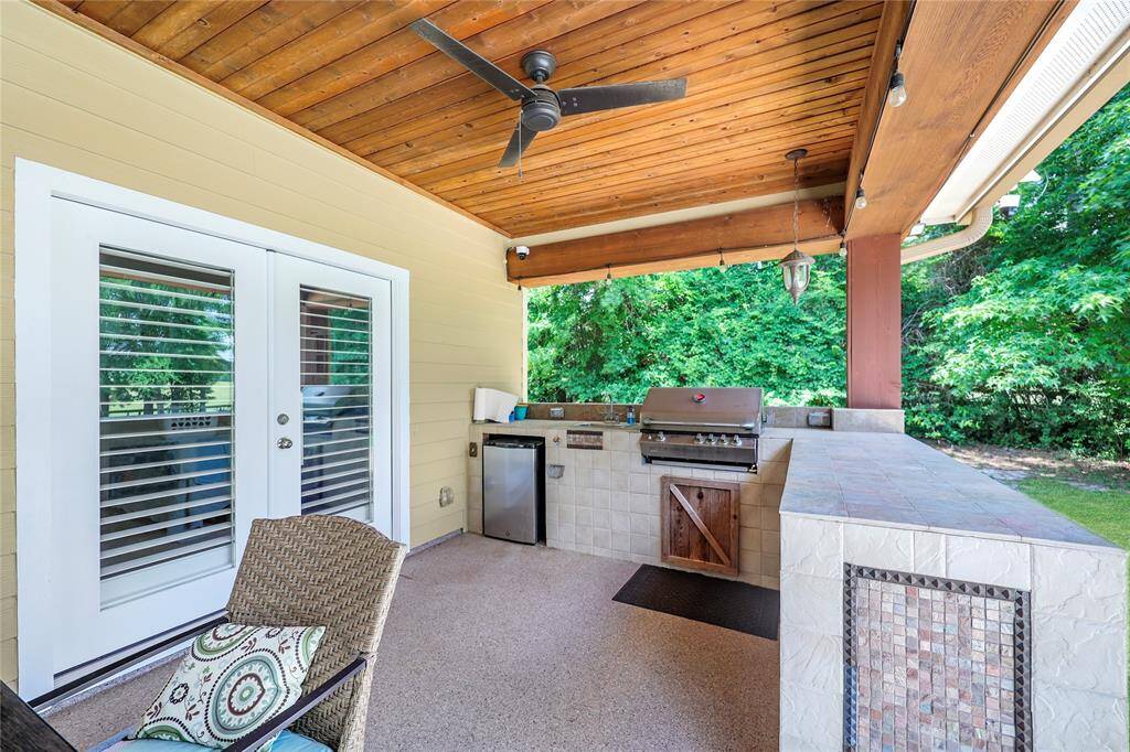The outdoor kitchen is complete with gas grill, sink, and space for a mini-fridge.