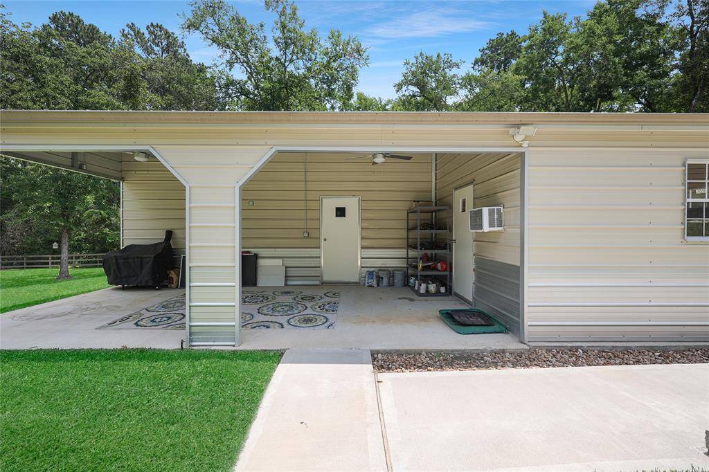 The metal building has a lean-to and expansive patio with ceiling fans and plugs for mounted TVs. There is an air conditioned storage room with 1/2 bath inside.