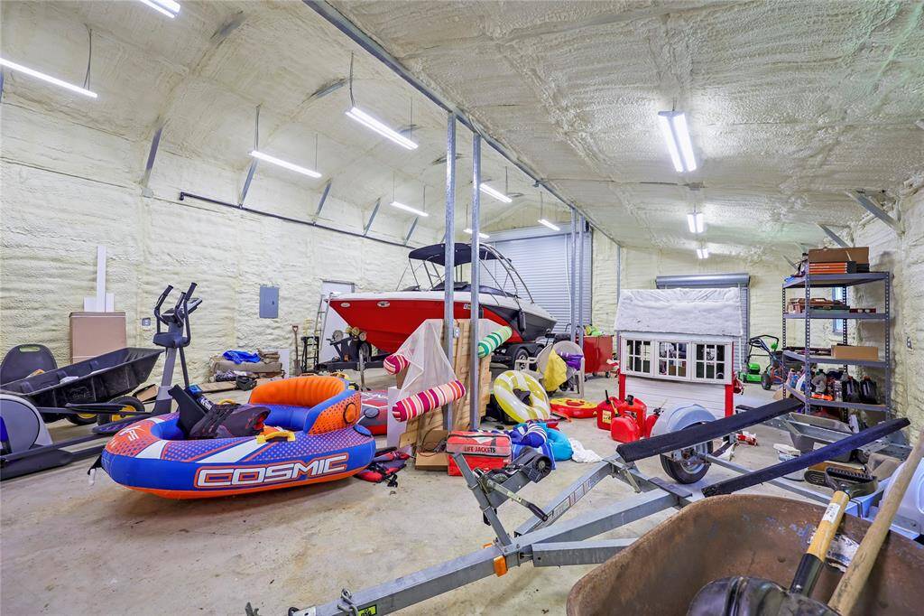The spacious, foam-insulated metal building offers ample room for boats, a RV, trailers, and recreational equipment. Perfect for hobbyists or those with active lifestyles. 220vac outlet & also has septic clean out available for an RV.