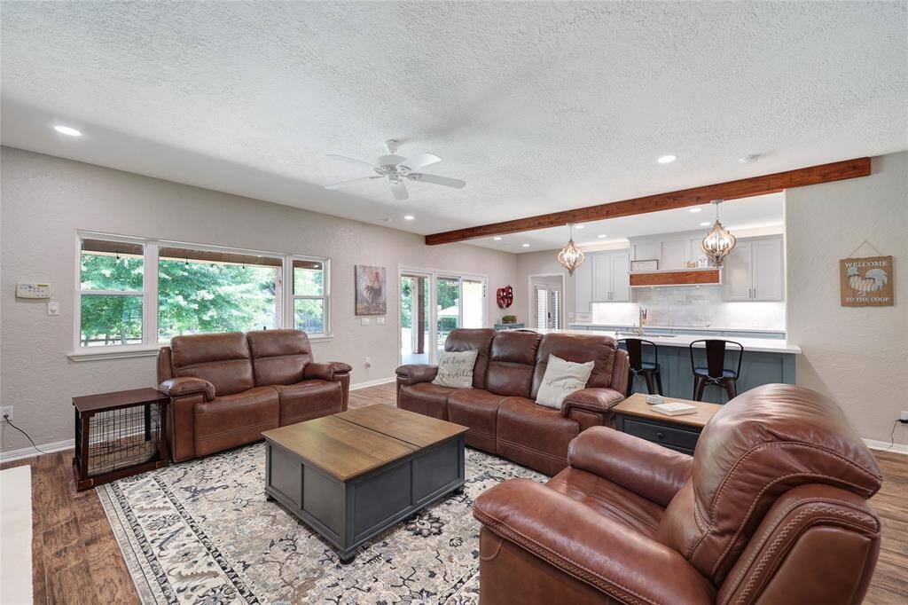This cozy living space is the heart of the home, featuring rich wood-look tile flooring and soft neutral walls. Large (new) low-e windows frame peaceful backyard lake & pasture views and allow natural light to flood the room.