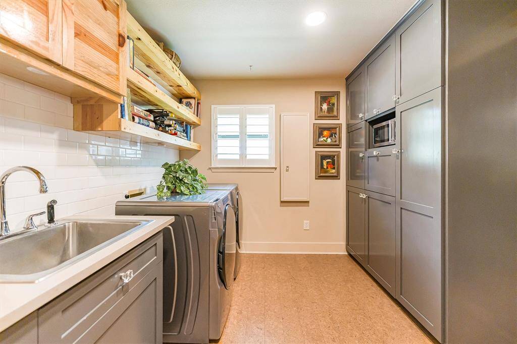 Utility room conveniently accessible through the kitchen.