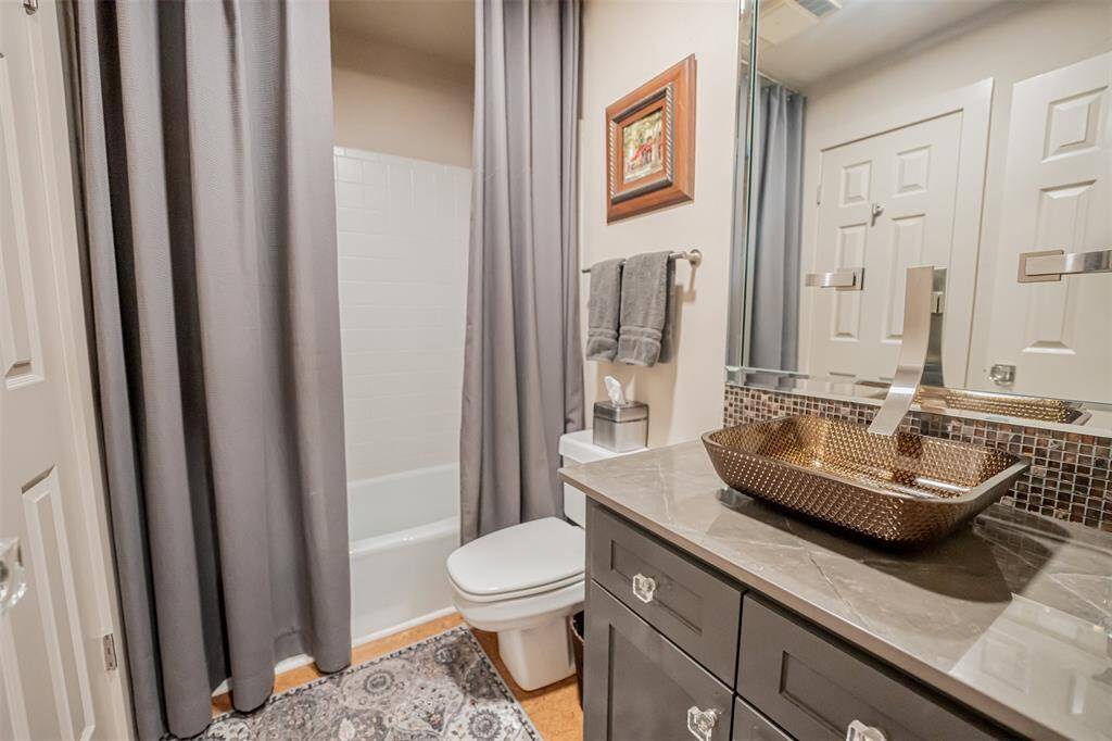 Main level guest bathroom featuring a modern vanity, stylish fixtures, and a clean, neutral color scheme