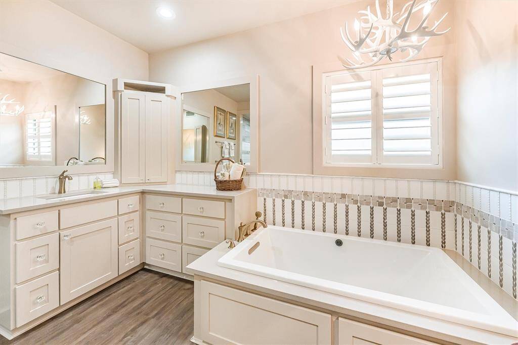 Spacious bathroom with his & her sinks, Kohler bubble soaker tub, and separate water closet
