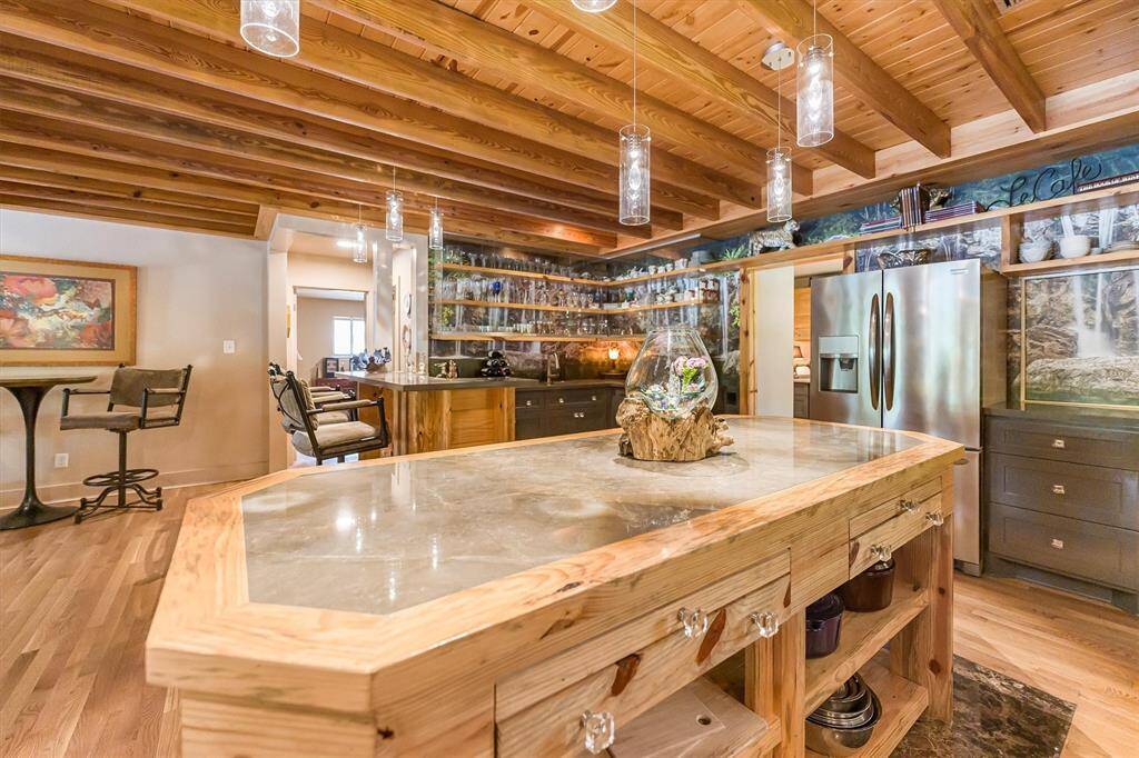 Custom island with 4 carving stations, built in drawers and open shelving, and Dekton stone countertop impervious to heat