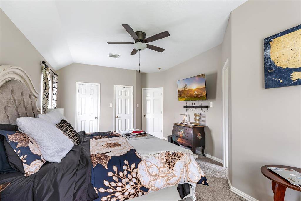 Primary bedroom facing entry door (the two doors on the left are the closet).